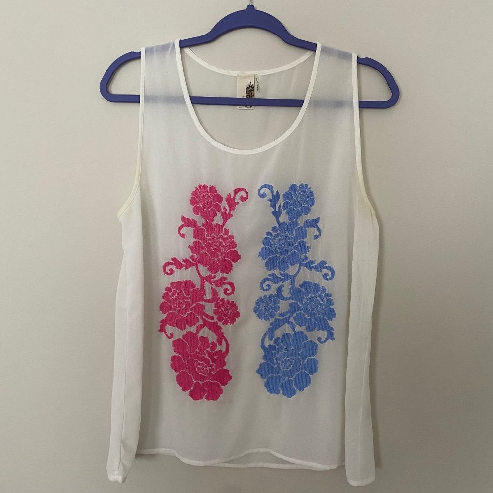 Francesca's white top with pink and blue stitching